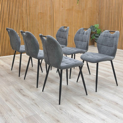 View of the backs of the Alva Charcoal Grey Dining Chairs.