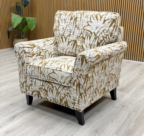 Side view of the ‘Pippa’ armchair, showcasing the detailed scroll arm profile and comfortable deep seat.