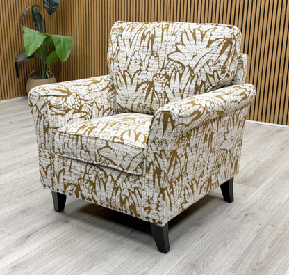 Side view of the ‘Pippa’ armchair, showcasing the detailed scroll arm profile and comfortable deep seat.