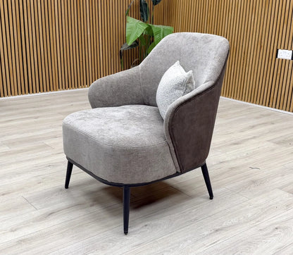 Side profile of the ‘Velar’ accent chair, showcasing the classic round arm style and comfortable deep seat.