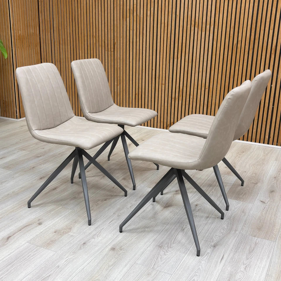 Full-view close-up of a single ‘Isaac’ Taupe Faux Leather Dining Chair, showcasing the smooth upholstery and slim metal legs.