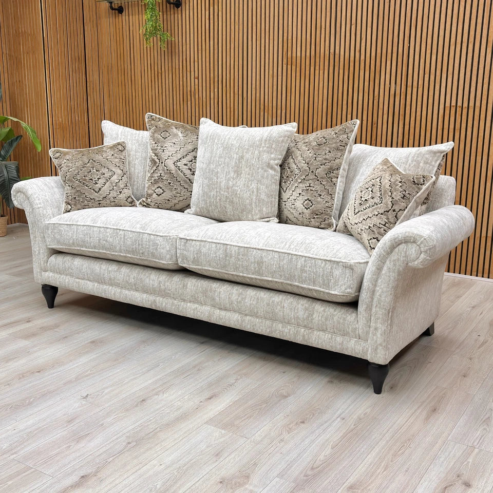 Angled view showing the sweeping rolled arms and profile of the sofa.