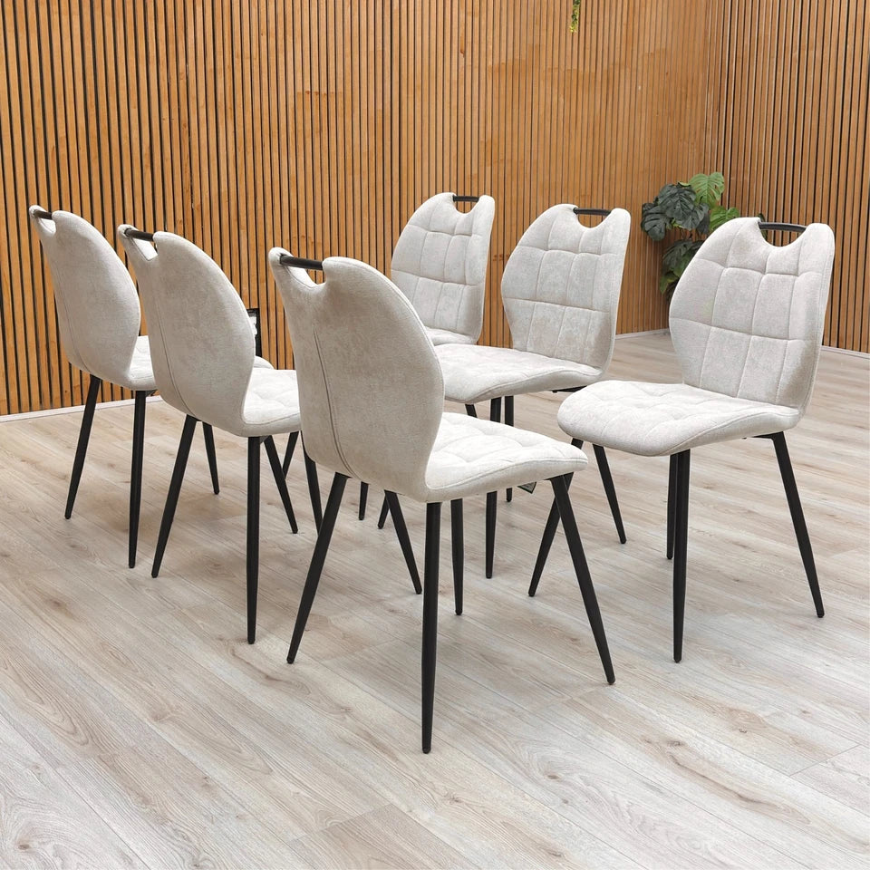 View of the backs of the Alva Beige Dining Chairs.