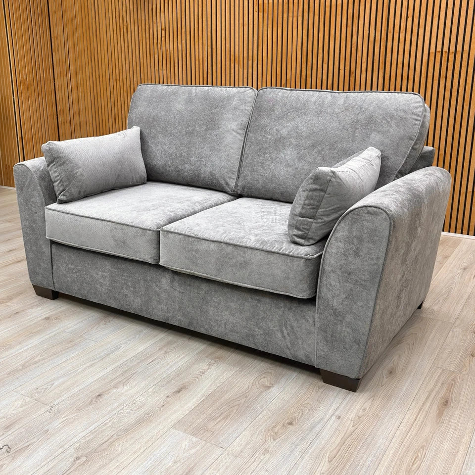 Detail shot focusing on the textured grey Kingston fabric and stitching on the armrest and seat of the sofa.