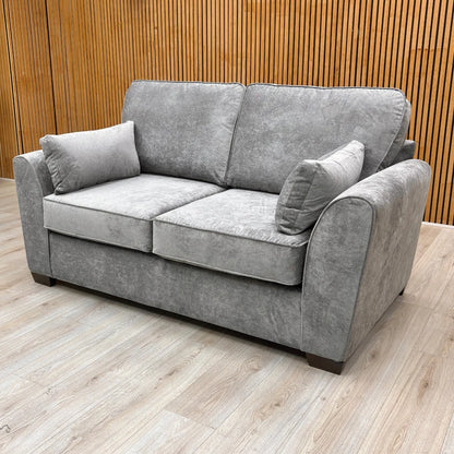 Detail shot focusing on the textured grey Kingston fabric and stitching on the armrest and seat of the sofa.