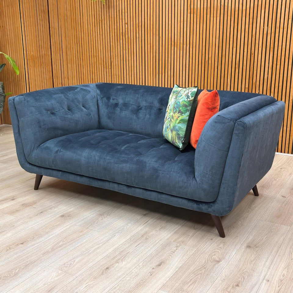The sofa's robust build, featuring a durable wood frame and quality velvet upholstery.