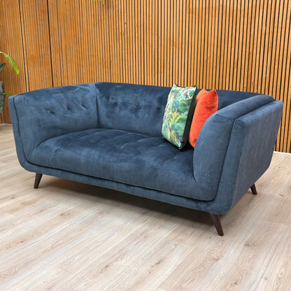 The sofa's robust build, featuring a durable wood frame and quality velvet upholstery.