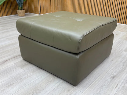 Side profile view of the 'Ava' footstool, showing its medium height and robust, solid structure.