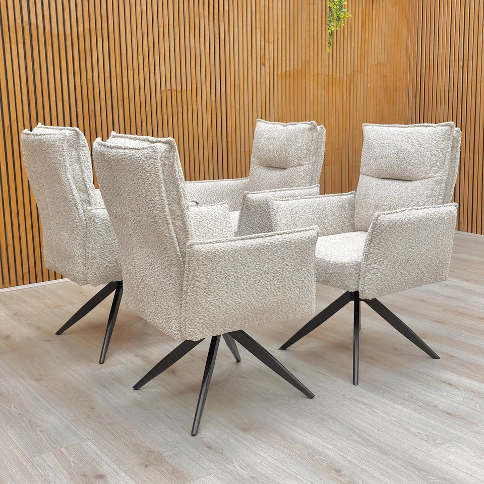 A set of four ‘Sarah’ Natural Mink Chenille Swivel Dining Chairs arranged around a dining table.