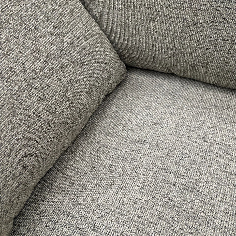 Close-up showing the detail of the fabric upholstery and stitching.