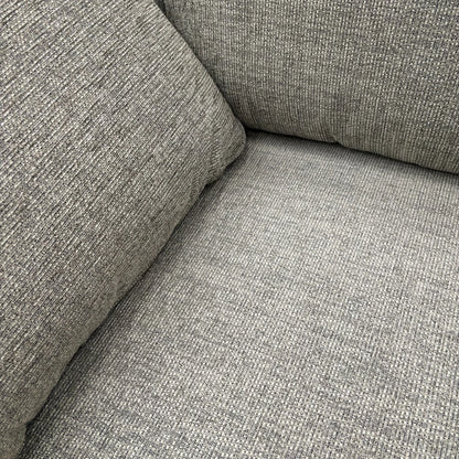 Close-up showing the detail of the fabric upholstery and stitching.