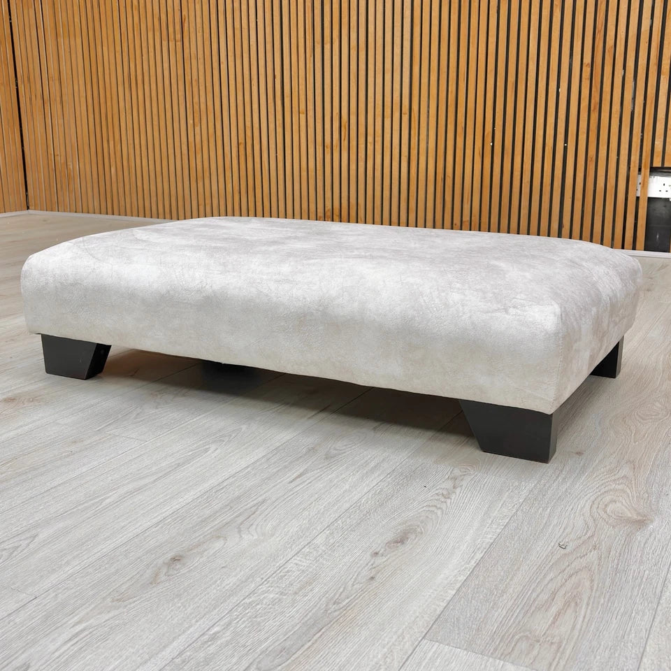 The 'Aura' footstool used as a designer accent piece in a living space.