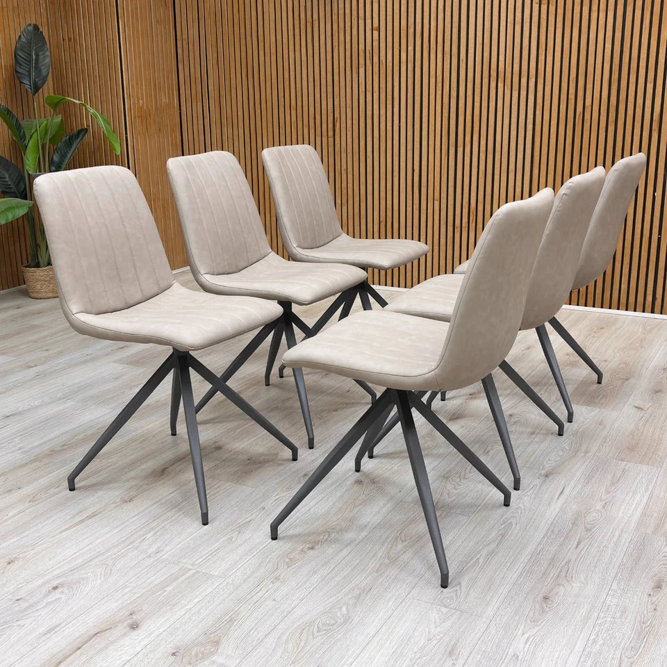 Full-view close-up of a single ‘Isaac’ Taupe Faux Leather Fixed Dining Chair, showcasing the smooth taupe faux leather and the sleek metal legs.