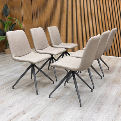 Full-view close-up of a single ‘Isaac’ Taupe Faux Leather Fixed Dining Chair, showcasing the smooth taupe faux leather and the sleek metal legs.