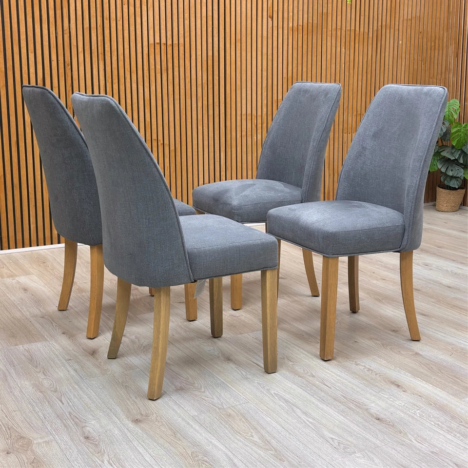 Lifestyle Detail of the solid wood legs on the Hamilton contemporary dining chair in a natural/dark finish.