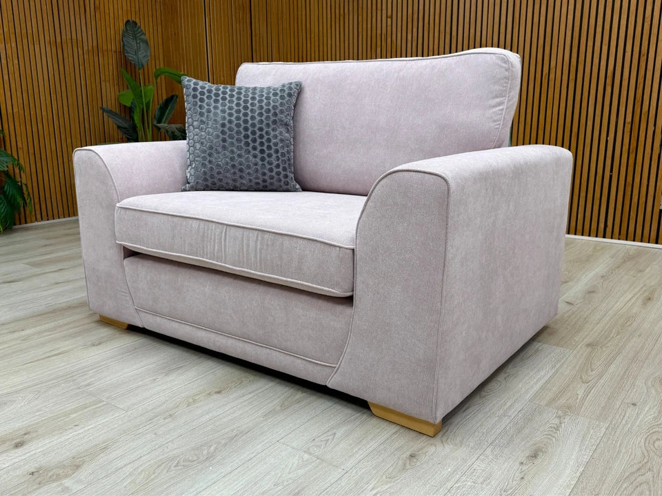 Side profile view of the Orka Cuddler Chair, showing the depth and removable arms feature.