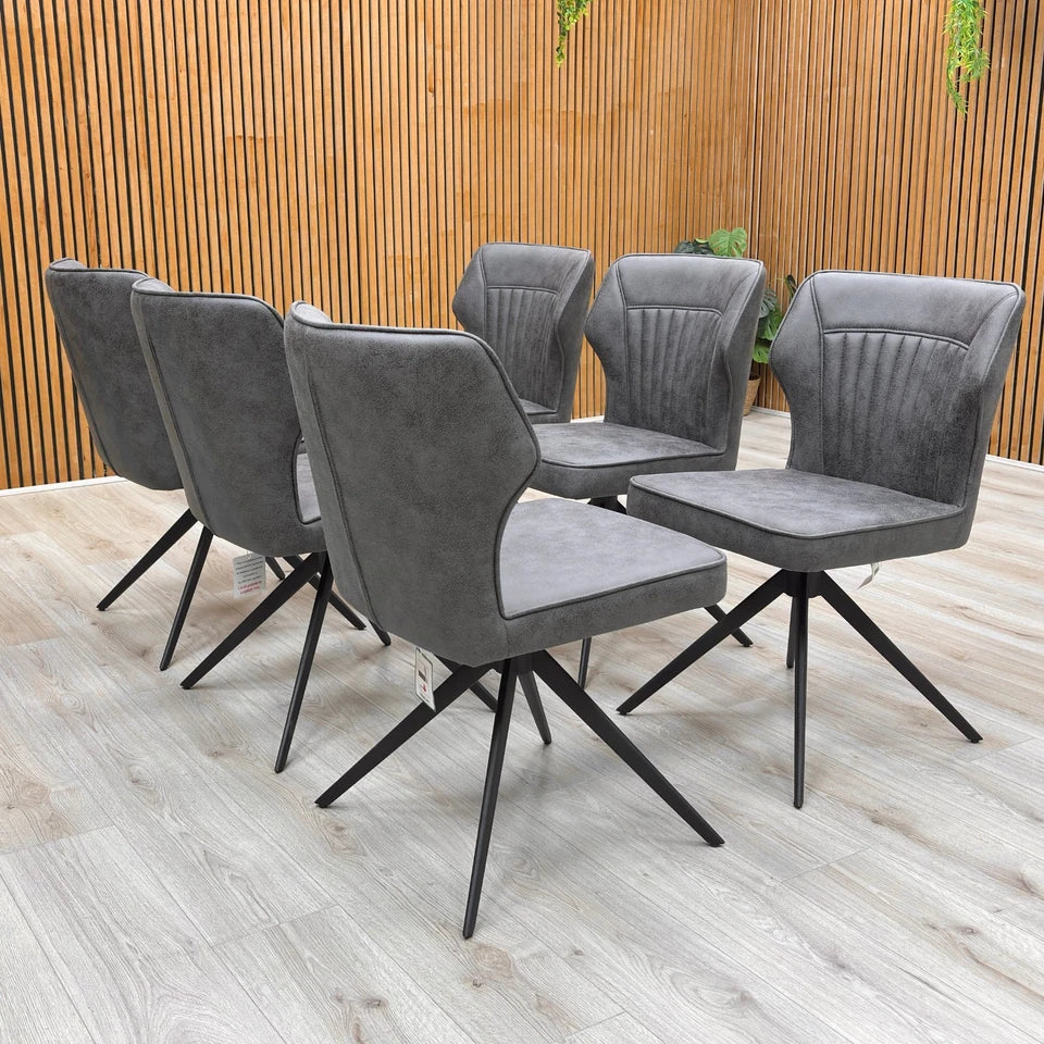 Lifestyle shot showing the Set of 6 Aydin Swivel Dining Chairs placed around a modern dining table.