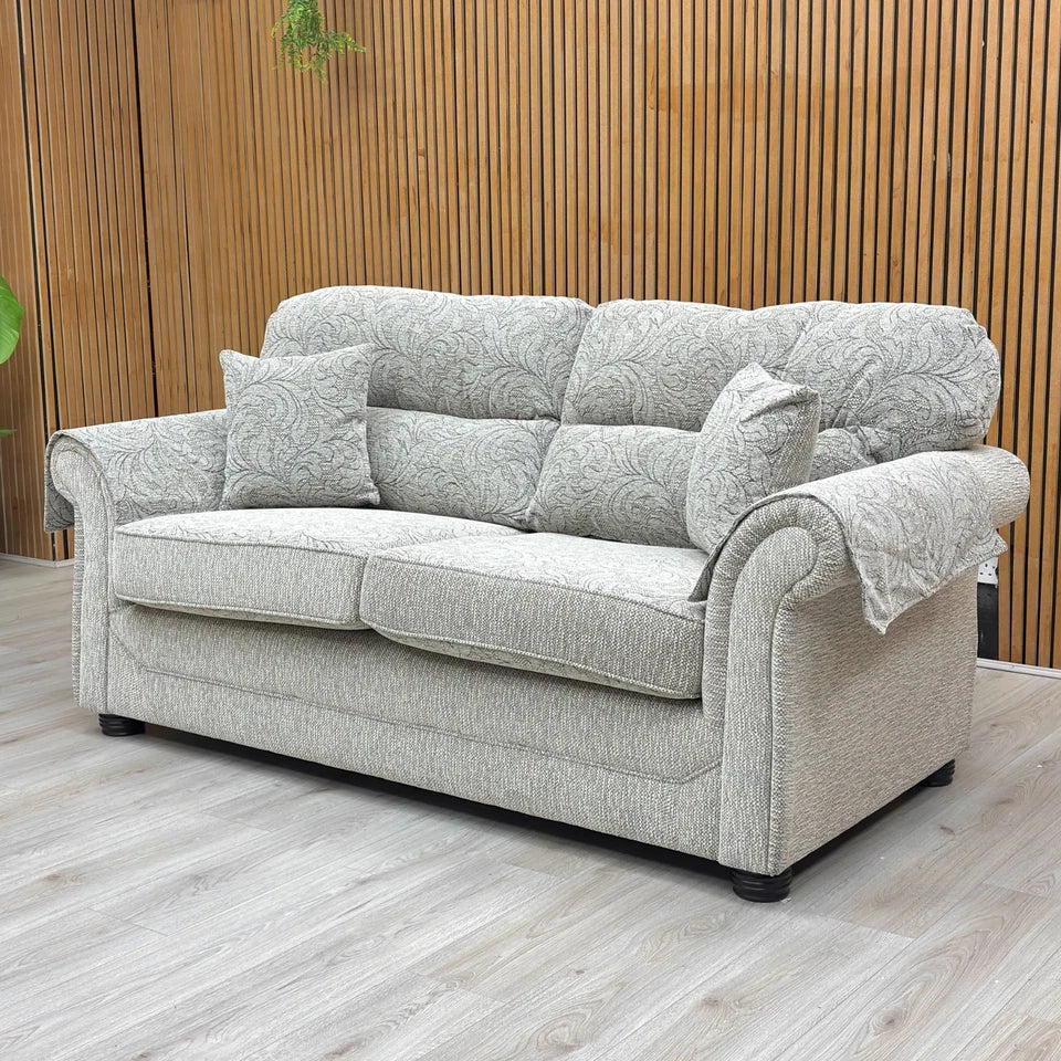 Lifestyle shot of the sofa, highlighting its scroll arms and high back.