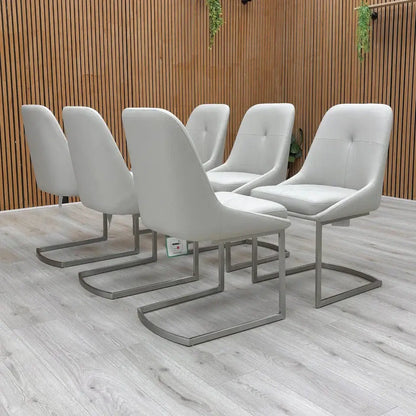 Set of six modern gray chairs on a wooden deck with a wooden wall background