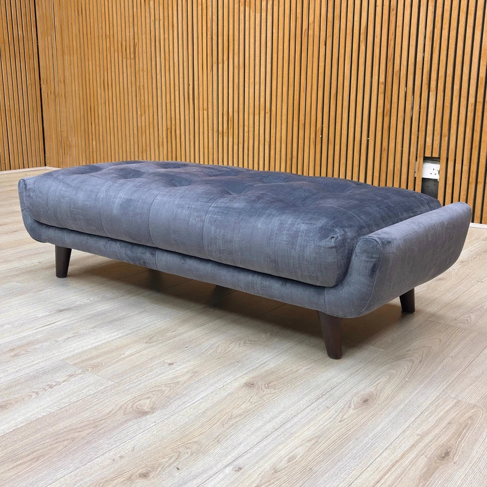 Lifestyle view showing the 'New Rene' Footstool being used as an extension or for lounging.