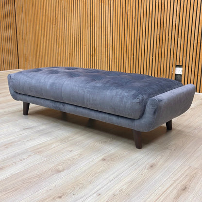 Lifestyle view showing the 'New Rene' Footstool being used as an extension or for lounging.