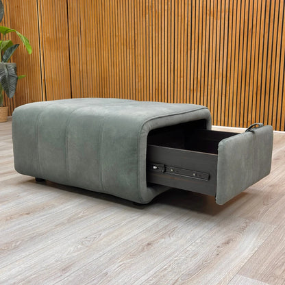 The 'Elphaba' Storage Footstool with the drawer-like pull-out storage compartment extended, revealing the internal space.