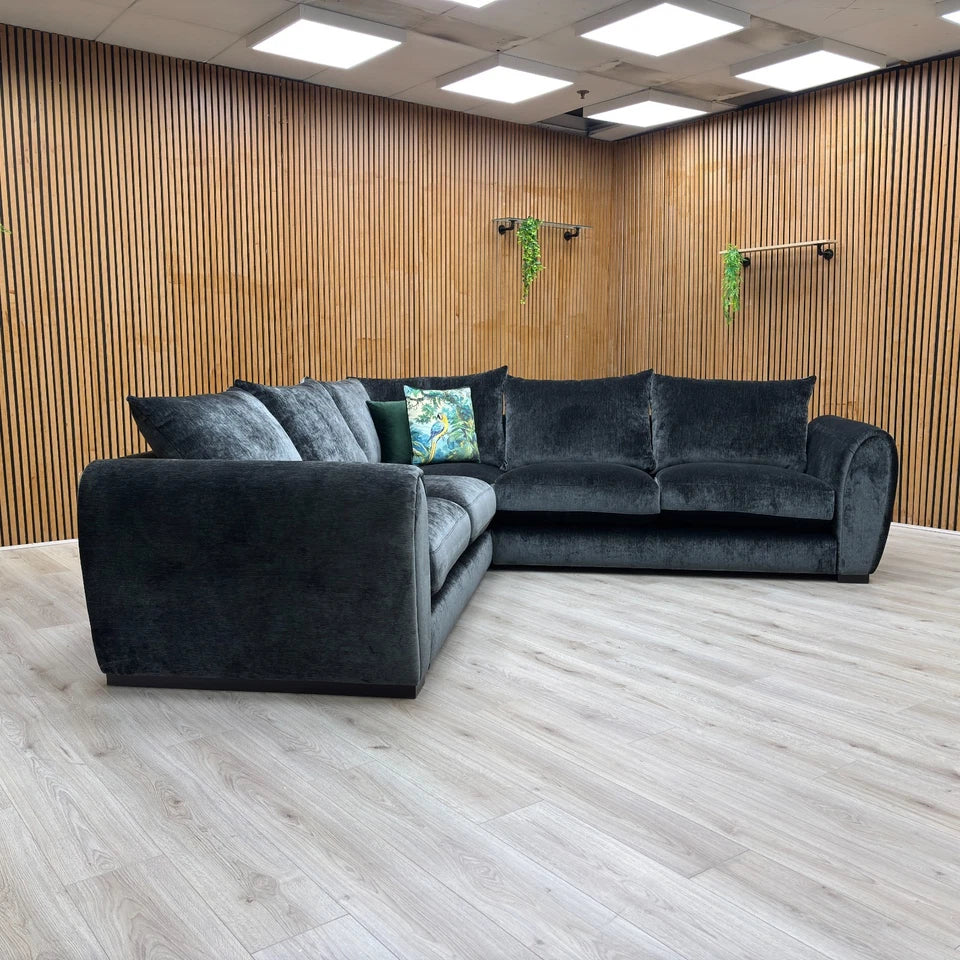 Detail shot of the sofa's sturdy arm and the quality of the tailoring and stitching on the velvet fabric.