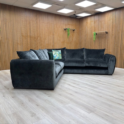 Detail shot of the sofa's sturdy arm and the quality of the tailoring and stitching on the velvet fabric.