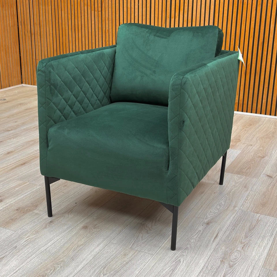 the back of the chair, highlighting the seamless velvet upholstery and curvature.
