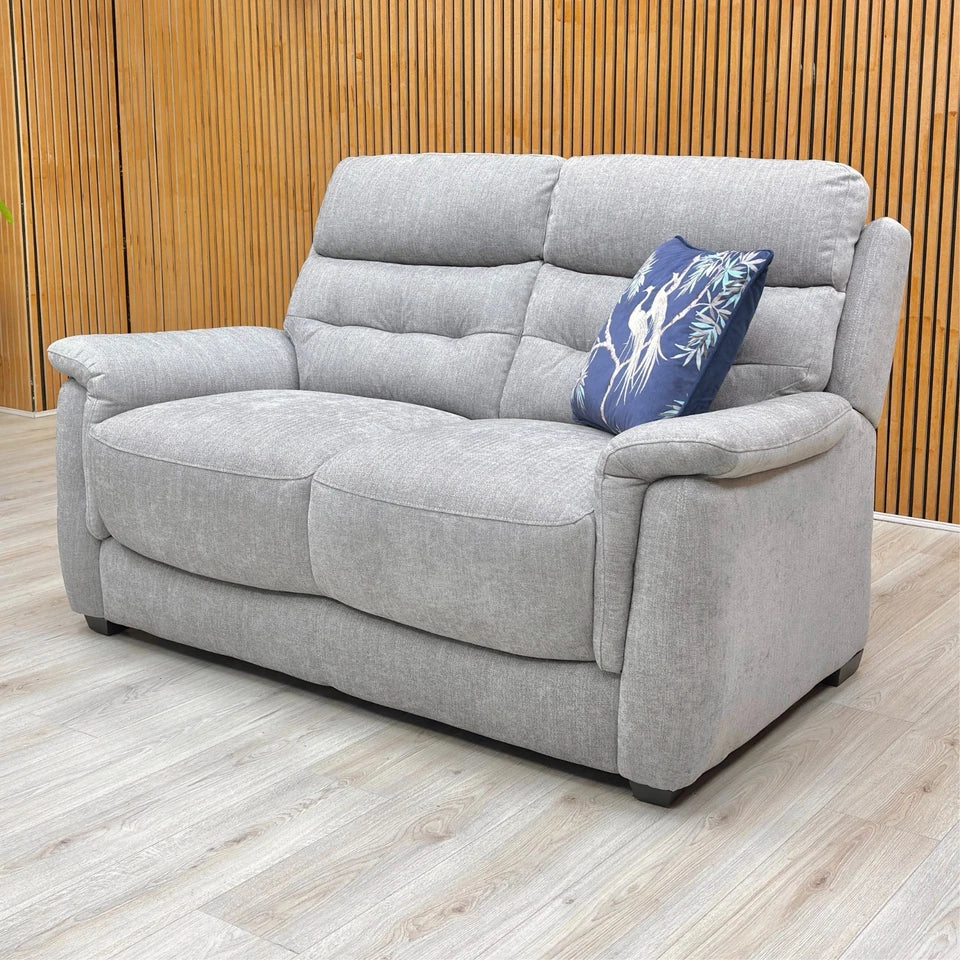 Detailed shot of the Pewter Fabric upholstery on the seat cushion, highlighting the medium comfort level and the thick padding on the armrest.