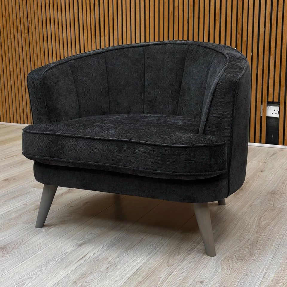 Side profile close-up of the 'Aurelia' Accent Chair, highlighting the texture of the Black Calix Boucle upholstery.
