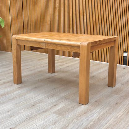 'Bakerloo' Small Solid Oak Wooden Dining Table set up in a dining area, emphasizing its compact size perfect for smaller spaces.