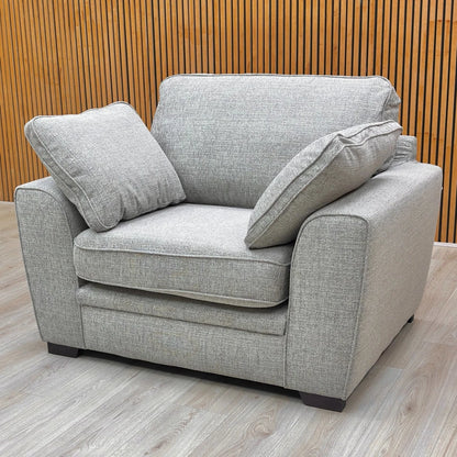 Front view of the Sort Silver Woven Fabric Armchair, showing the low, contemporary design and wooden feet.