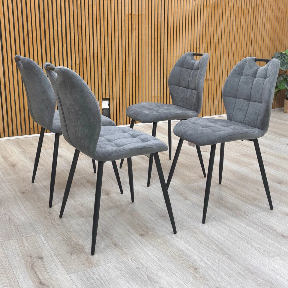 View of the backs of the Alva Charcoal Grey Dining Chairs.