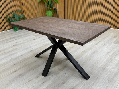 Lifestyle shot showing the 'Mars' Dark Oak Solid Oak Compact 135cm Fixed Dining Table.