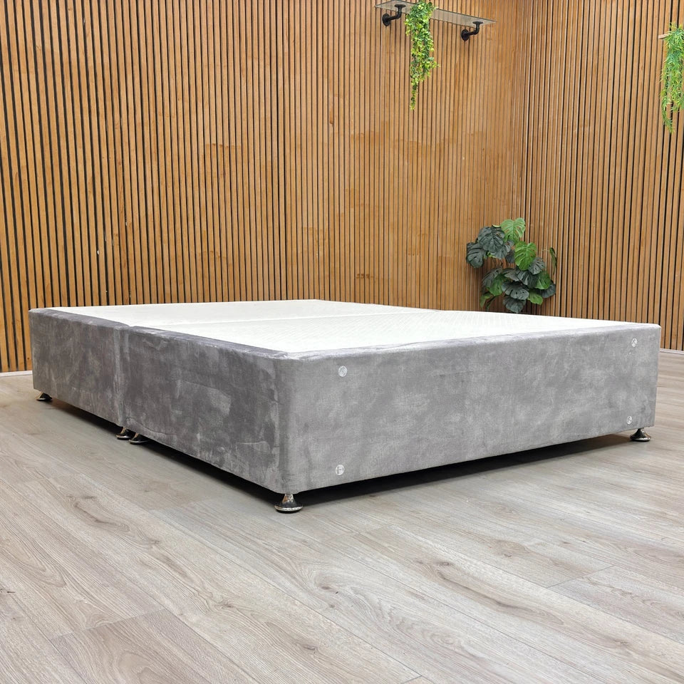 Lifestyle image of the Lace Dolphin Velvet Double bed base, featuring a contemporary low-profile design on wooden feet.