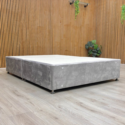 Lifestyle image of the Lace Dolphin Velvet Double bed base, featuring a contemporary low-profile design on wooden feet.