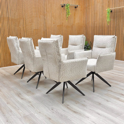 The 'Sarah' dining chair set around a dining table, highlighting its scale and stylish appearance.