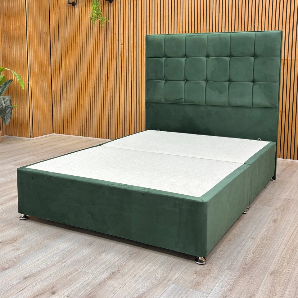 Detail of the base of the Emerald Green Velvet divan, showing the wooden feet/legs and the lower edge of the base.