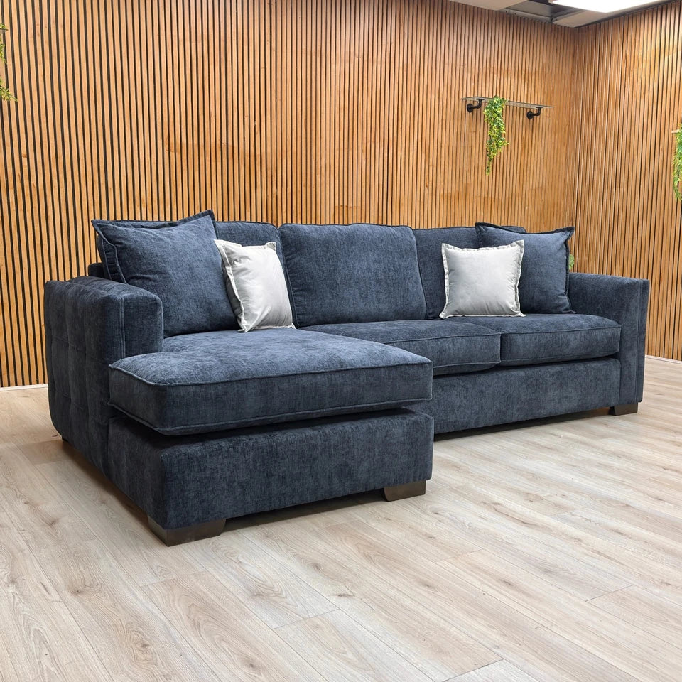 High-angle or overview shot of the navy blue corner chaise, clearly illustrating the L-shape and the armless left-hand open-end design.