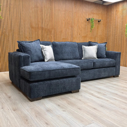 High-angle or overview shot of the navy blue corner chaise, clearly illustrating the L-shape and the armless left-hand open-end design.