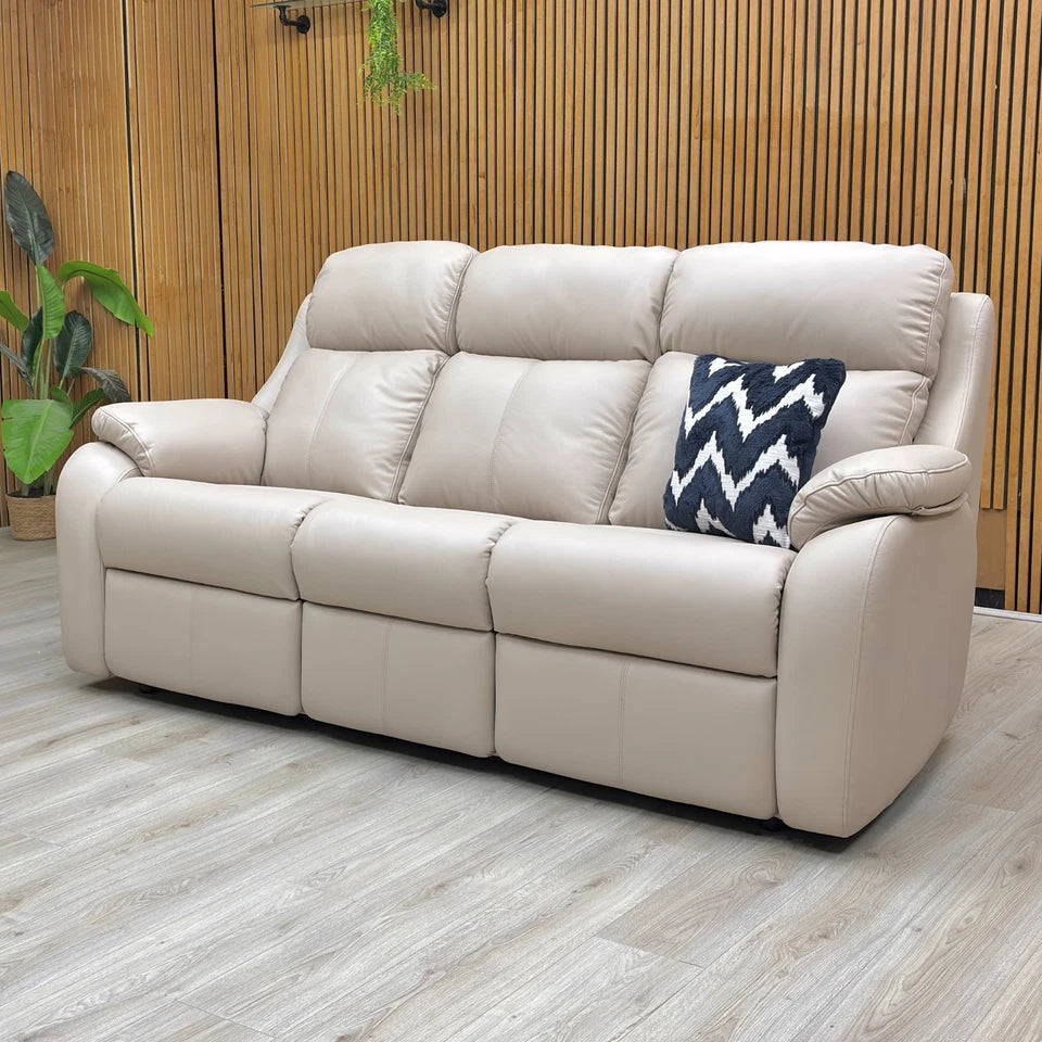 Lifestyle shot of the G Plan Kingsbury 3 seater sofa in a bright living room, showcasing the soft plaster-toned leather and elegant wing details.