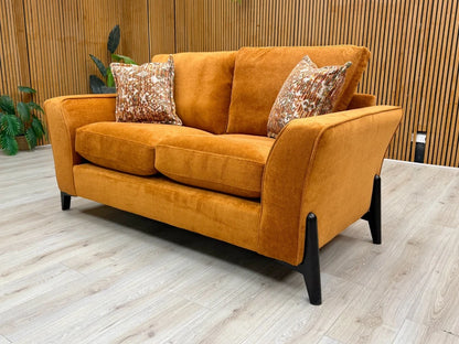 Side view of the 'Collins' 2-seater sofa in almond orange, showing the height and profile of the backrest and sloped arm.