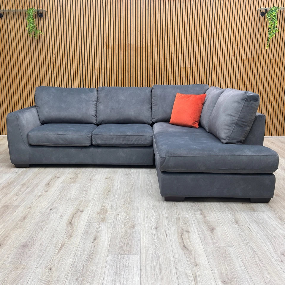 Lifestyle shot of the 'Dinky' Dexter Corner Chaise Sofa, highlighting its compact proportions and stylish curves.