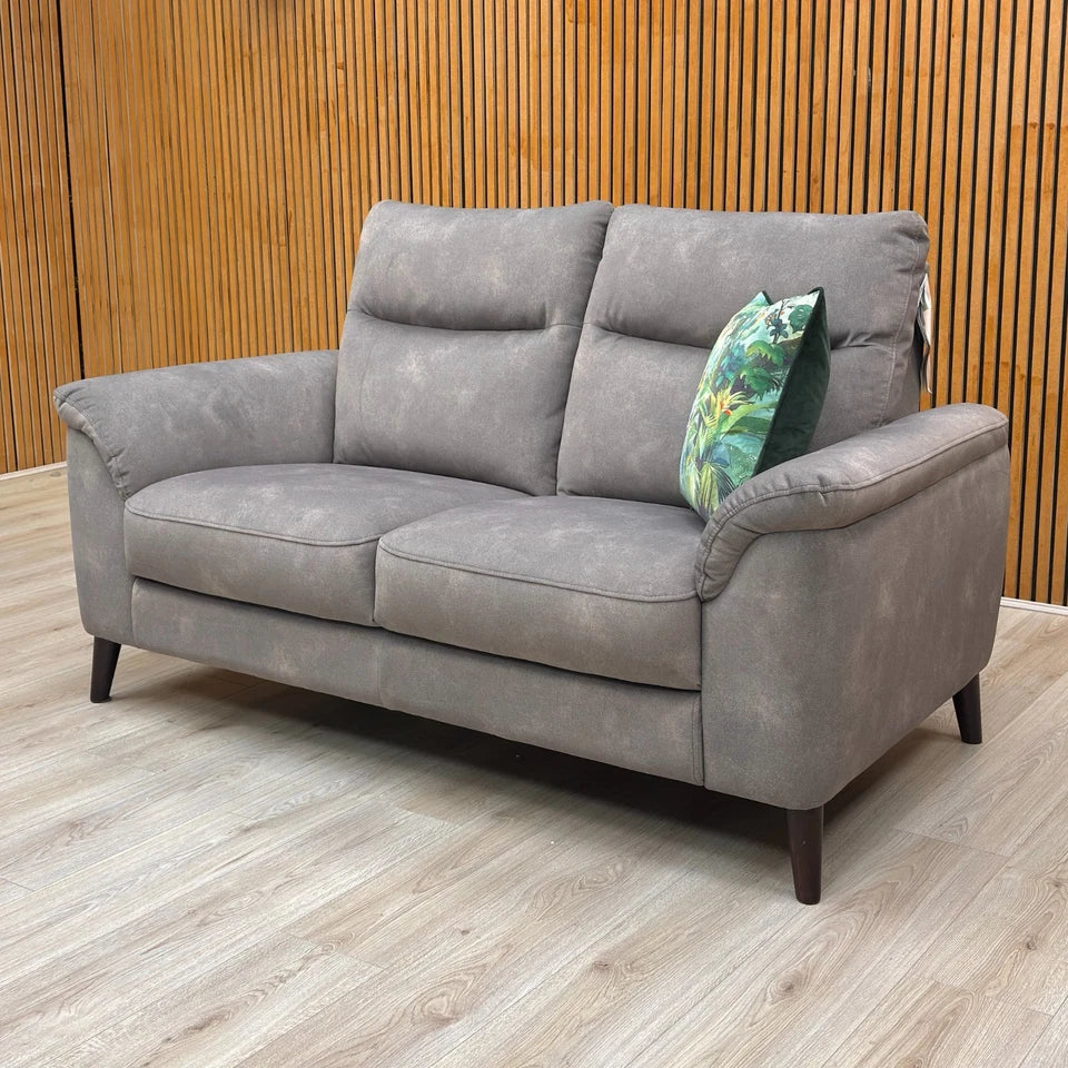 Detailed view of the modern metallic tapered legs supporting the Dexter Mocha Velvet Sofa.