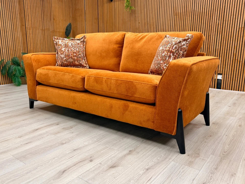 Side view of the 'Collins' sofa, clearly showing the continuous line of the sloped armrest and the generous depth of the seating.