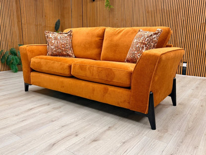 Side view of the 'Collins' sofa, clearly showing the continuous line of the sloped armrest and the generous depth of the seating.