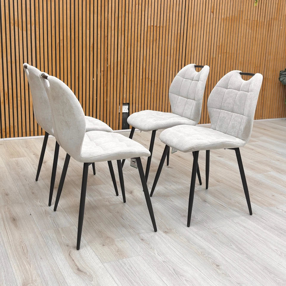 View of the backs of the Alva Beige Dining Chairs.