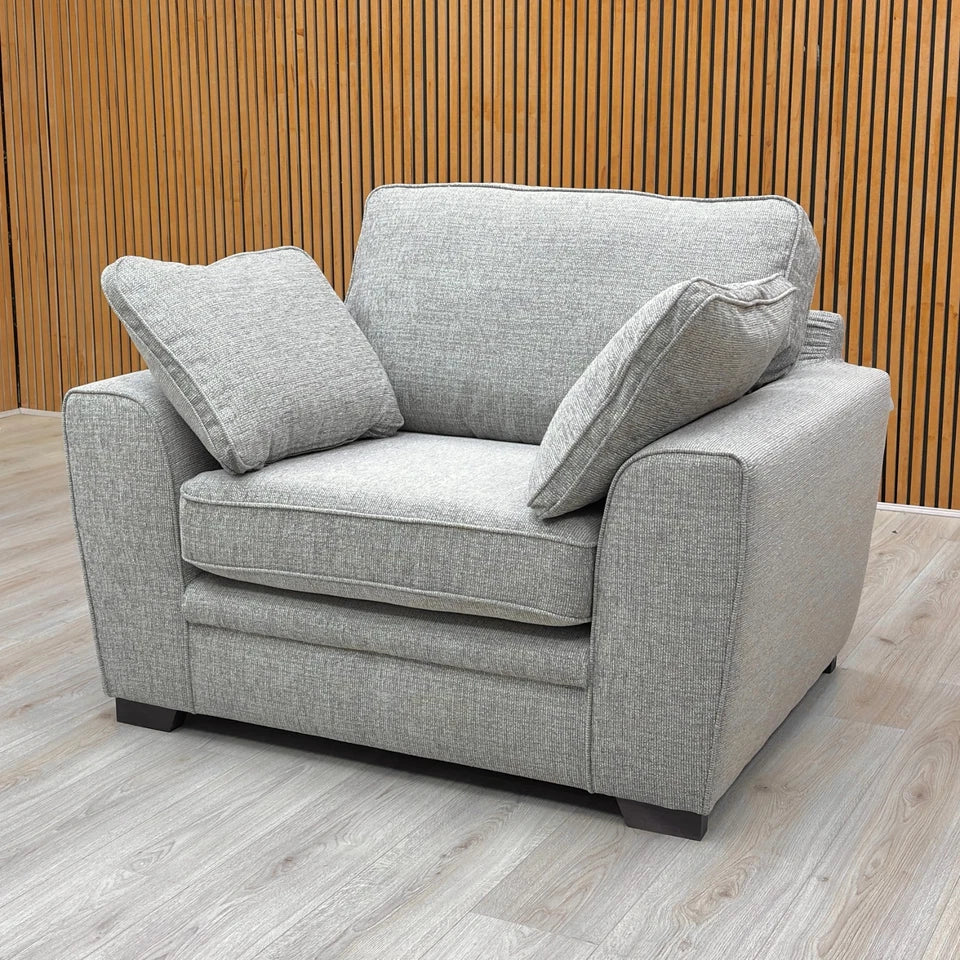 Side-angled close-up of the armchair, highlighting the cushioned arm and the fabric texture.