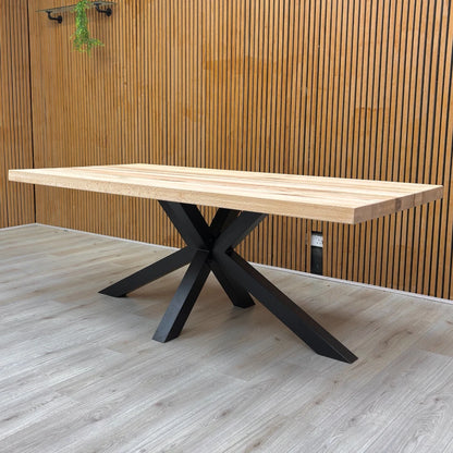 Lifestyle photo showing the Bodahl industrial table set for dining in a modern home environment.